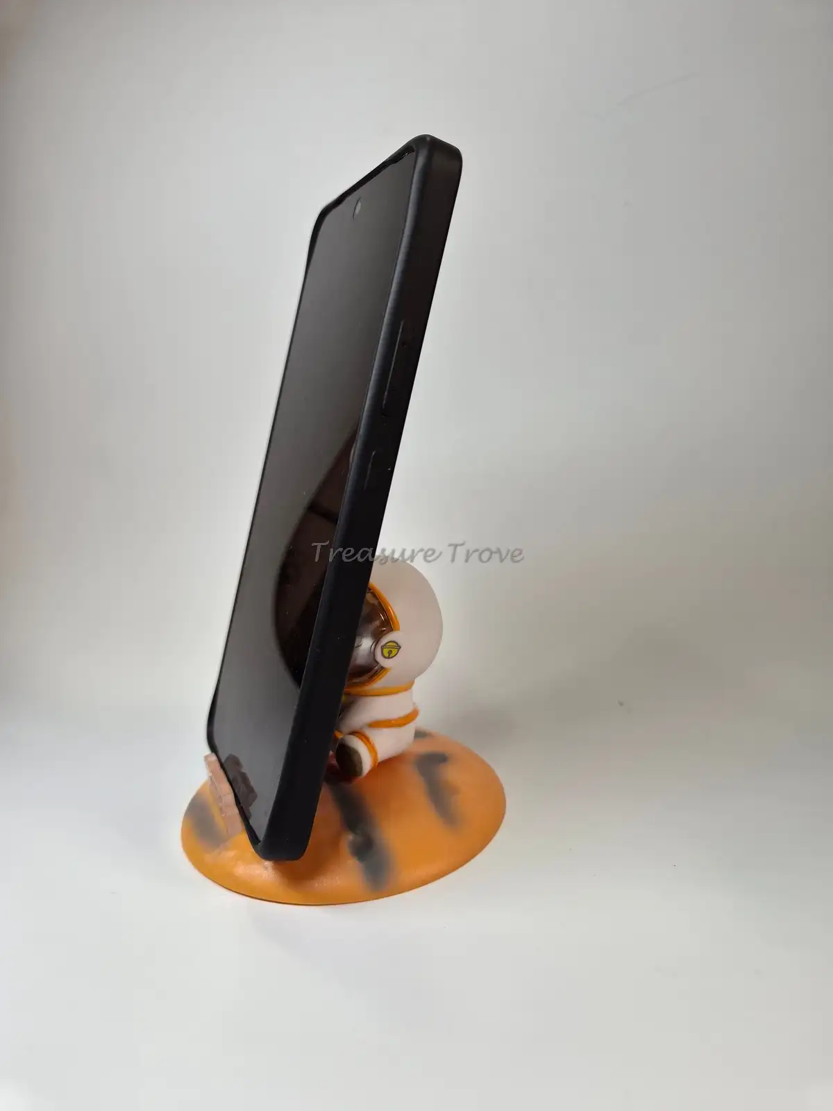 Sitting Astronaut Mini Showpiece on Orange Planet Phone